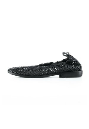 Black perforated leather ballet flat with elasticized back and small heel, shown in profile on white background.