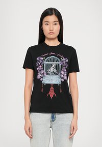 Black cotton t-shirt featuring a colorful graphic design of a birdcage with flowers and tassels. Crew neck and short sleeves.
