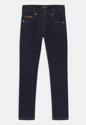 Dunkelblaue Skinny-Jeans mit oranger Naht, fünf Taschen, darunter eine Münztasche, und einem Knopfverschluss an der Taille.
