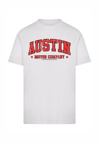White cotton t-shirt with a red distressed graphic reading "AUSTIN MOTOR COMPANY" in bold uppercase. Crew neck, short sleeves.