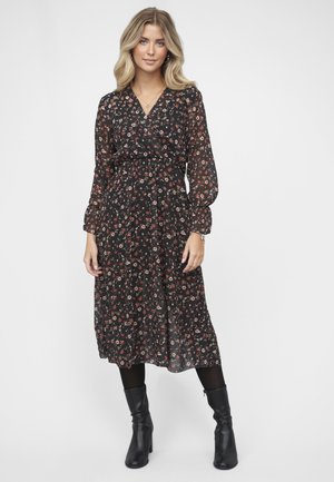 Schwarz-blumiges Kleid mit langen puffärmel, einem Wickeldesign und einer taillierten Taille. Verziert mit kleinen roten und weißen Blumen und einem schwingenden Rock.