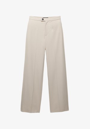 Beige vida byxor gjorda av slätt tyg. Har en frontknäppning och sidofickor. Skräddarsydd design med pressade veck.