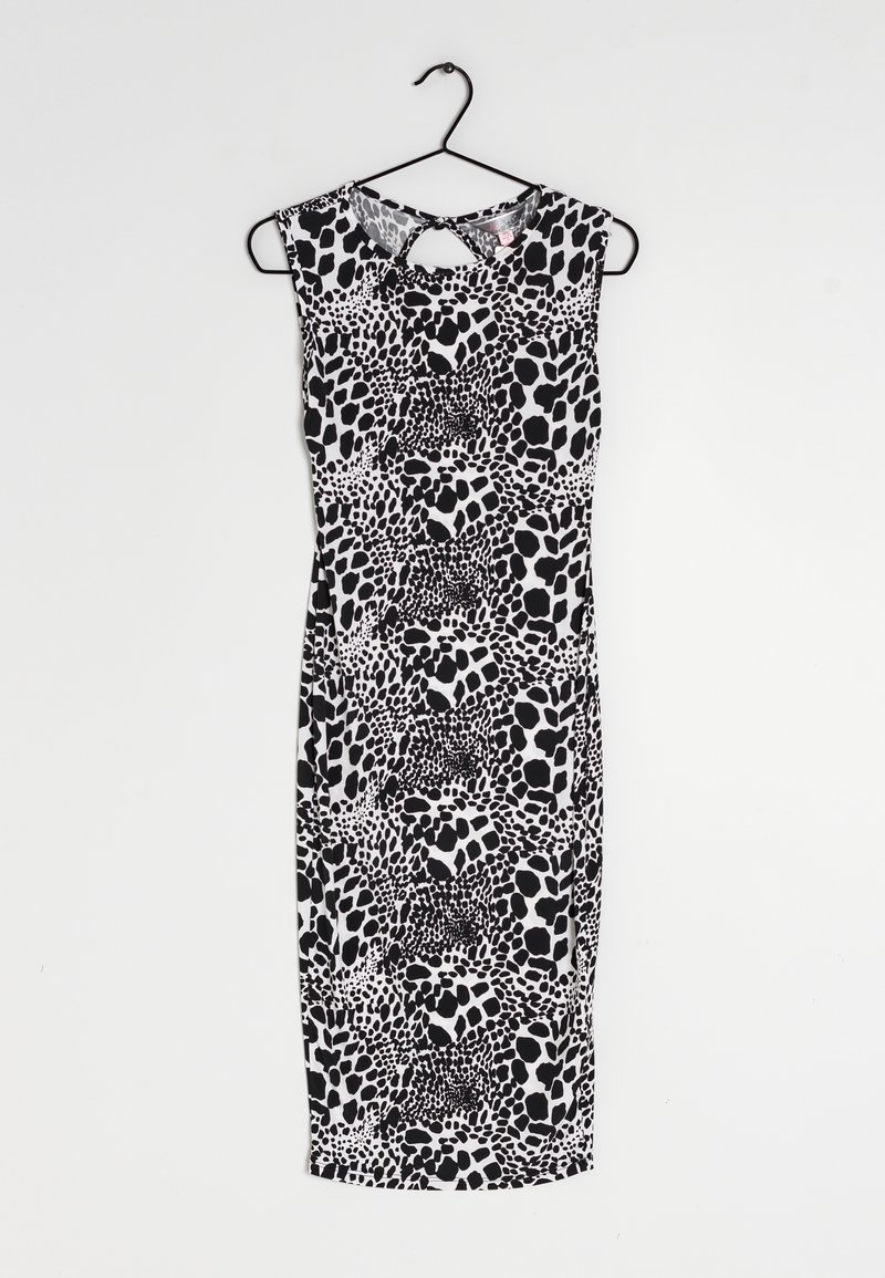 Robe sans manches en noir et blanc avec une silhouette ajustée, présentant un motif à pois, un col rond et un détail en trou de serrure au dos.