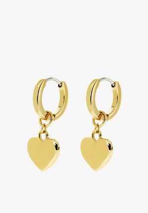 Boucles d'oreilles créoles en or, chacune avec un pendentif lisse en forme de cœur pendant, présentées sur un fond blanc.