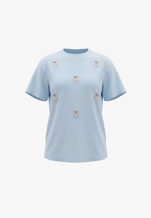 Lys blå kortærmet t-shirt med flere broderede kaninansigter pyntet med perler og blomster på forsiden.