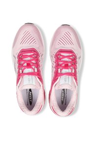 Light pink athletic shoes with pink laces, breathable mesh fabric, textured detailing, and a cushioned sole. Design includes a logo on the tongue.