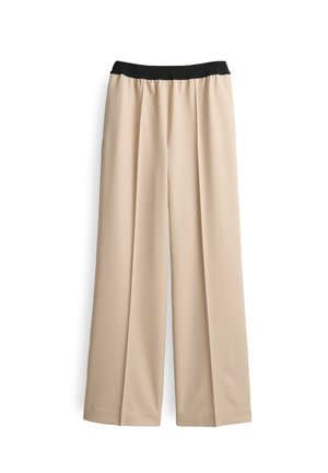 Pantalon beige à jambes larges avec un waistband élastique noir, plis plats à l'avant et ourlet droit, présenté sur fond blanc.