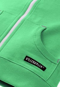 Green zip-up hoodie with ribbed cuffs and hem. Features a white zipper and a black label reading "VILLERVALLA" on the front.