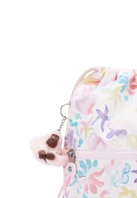 Drawstring bag with a floral pattern in pastel colors, featuring a plush monkey keychain and a zippered pocket. Made of lightweight fabric.
