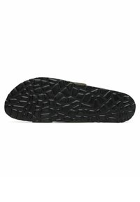 Semelle de chaussure en caoutchouc noir présentant un motif texturé avec diverses formes géométriques, conçue pour l'adhérence et la durabilité.