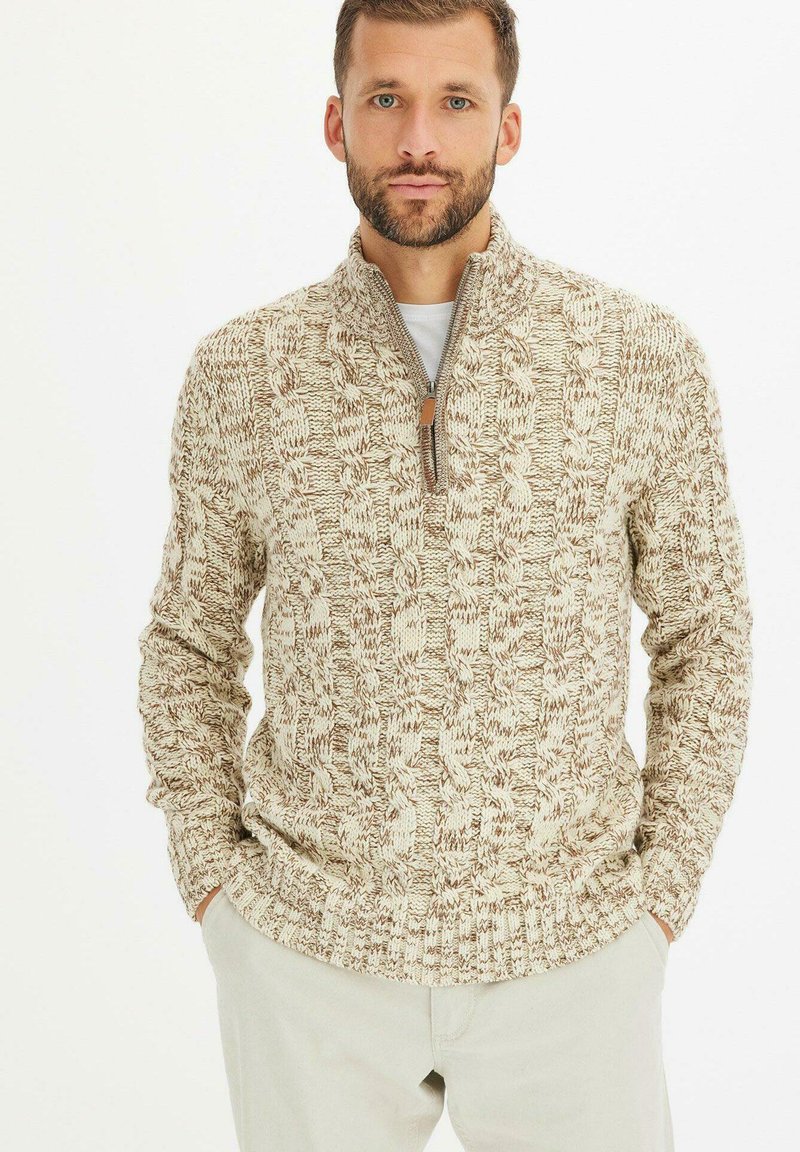 Maglione beige a maglia con un motivo testurizzato, dotato di colletto con zip, orlo a coste e maniche lunghe. Materiale morbido di peso medio.