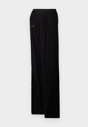 Czarne lekkie spodnie o luźnym kroju. Posiadają elastyczny pas z sznurkiem, zakładki oraz złote akcenty na końcach sznurka.