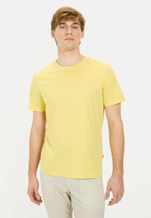 Short-sleeve yellow t-shirt made of cotton, features a round neckline and straight cut. Minimal branding near the chest and side hem.