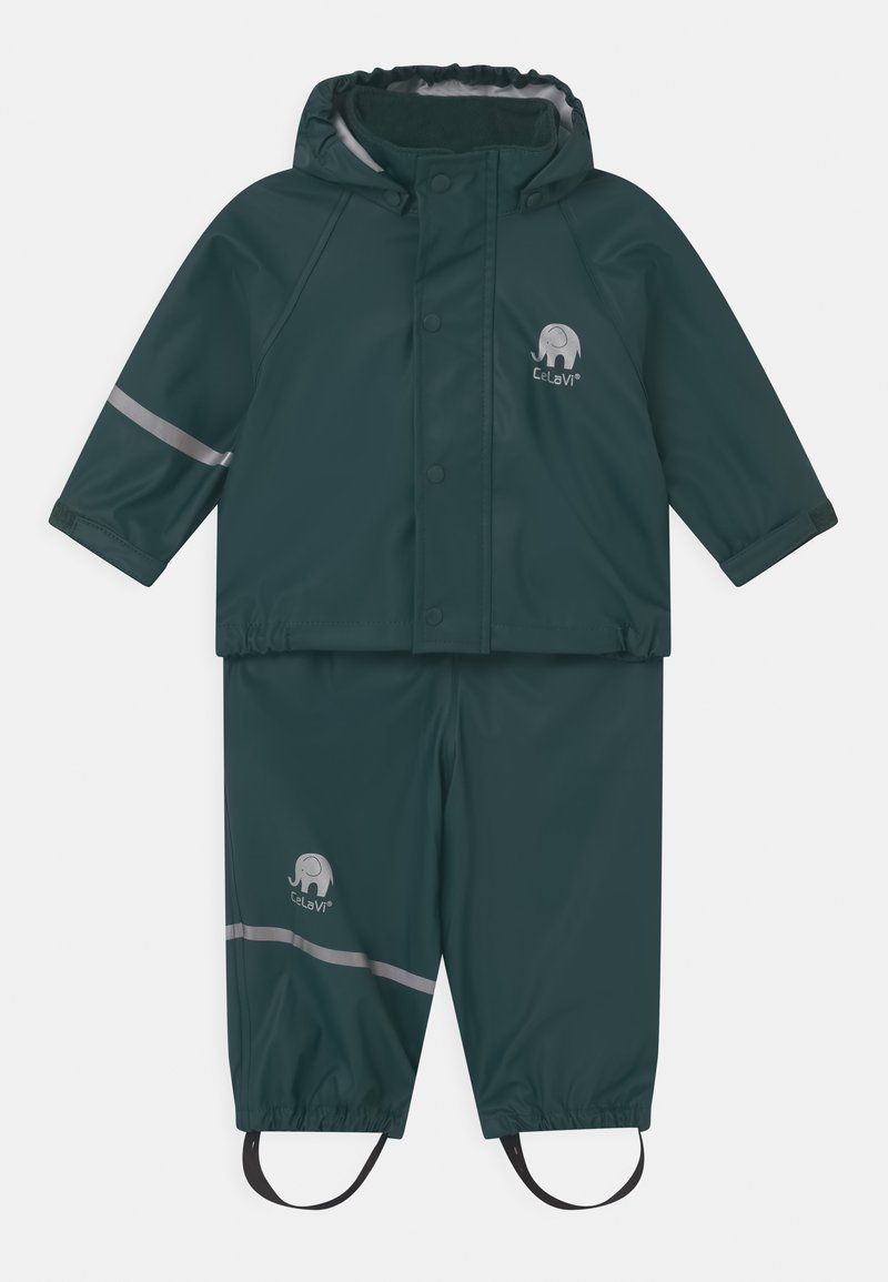 Temno zelena vodoodporna dežna obleka s kapuco, ki ima odsevnike, elastične manšete in logotip slona. Vključuje nastavljive nogavice.