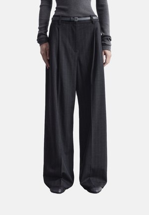 Wide-leg, grey pinstriped trousers with pleats and a belt. Made of textured fabric, featuring a tailored design and relaxed fit.