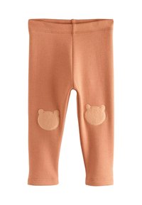 Legginsy w kolorze brzoskwiniowym, wykonane z miękkiej bawełny. Posiadają łatki w kształcie misia na obu kolanach. Elastyczny pas zapewniający wygodne dopasowanie.