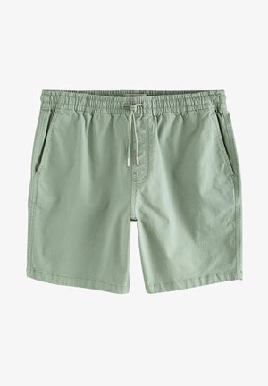 Shorts verde chiaro realizzati in tessuto morbido, dotati di una vita elastica con cordoncino, due tasche laterali e un design semplice.