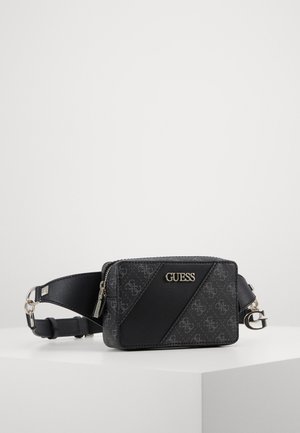 Black Guess rectangular belt bag with diagonal logo pattern, gold-tone hardware, and adjustable strap on white surface.
