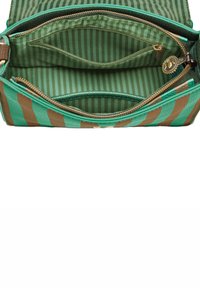 Green and brown striped handbag interior with two zippered pockets, featuring a textured lining and metal hardware for closure.