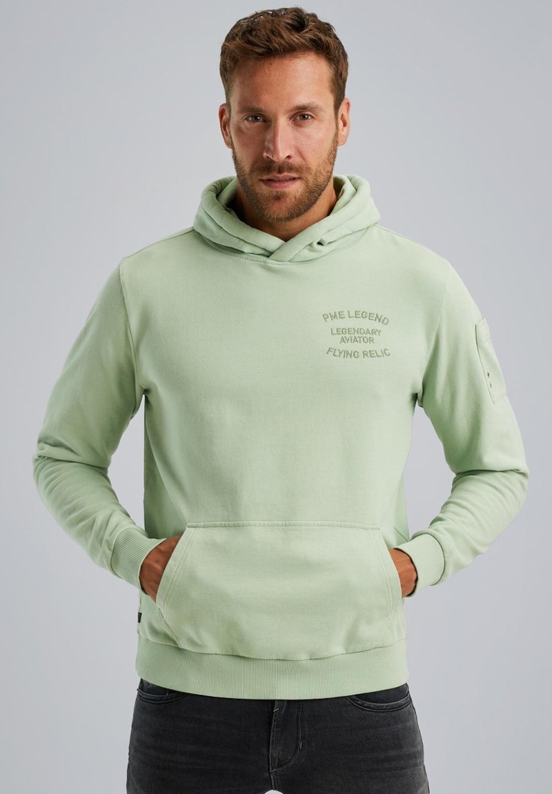 Sudadera con capucha de color verde menta, con un bolsillo canguro en el frontal, puños acanalados y logo bordado en el pecho. Tejido suave, diseño casual.