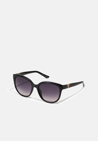 Black sunglasses with a large square frame and gradient lenses. Features a subtle logo accent on the outer side of the temple.