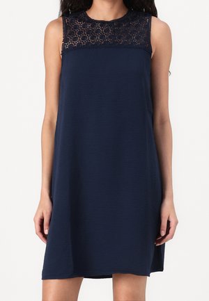 Navy sleeveless dress featuring a textured body and intricate lace yoke detail. The design is relaxed fit, with no visible hardware or embellishments.