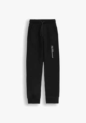 Czarne dresy z miękkiego materiału, z bocznymi kieszeniami, elastycznym pasem na sznurki i nadrukowanym hasłem na nodze. Żebrowane mankiety.