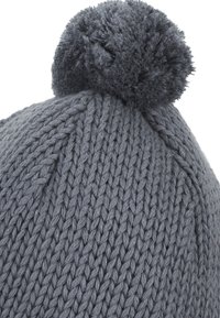 Gray knitted beanie with a textured pattern, featuring a soft, fluffy pompom on top. Material appears thick and warm.