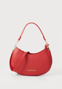 Red leather handbag with textured pattern, gold accents, and a curved design. Features a short handle and a removable shoulder strap.