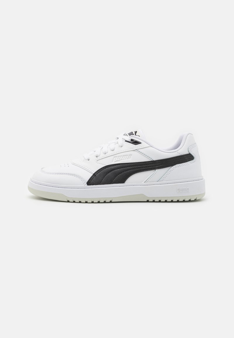 White sneakers with black and grey accents, featuring a smooth leather upper, round toe, lace-up design, and textured rubber sole.