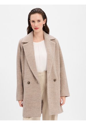 Beige Wollmantel mit entspannter Passform, breiten Revers und doppelt geknöpftem Design. Ausgestattet mit einem strukturierten Stoff und runden braunen Knöpfen.