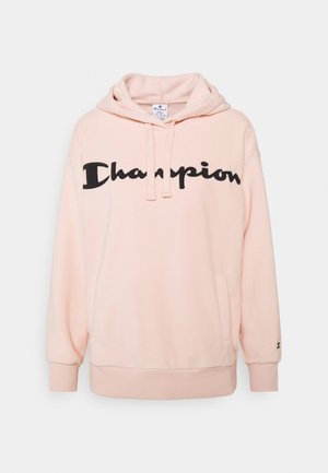 Felpa rosa chiaro realizzata in morbido tessuto, con un grande logo nero "Champion" sul davanti, cordini e polsini a coste.