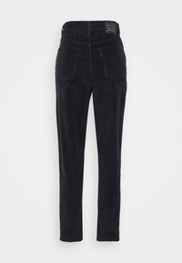 Pantalon en velours côtelé noir avec une coupe droite, doté de poches arrière proéminentes et d'une étiquette sur la ceinture. Texture douce, motif côtelé.