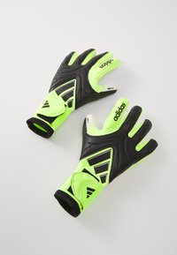 Adidas goalkeeper gloves in black and neon green, featuring textured grip, elastic wristbands, and logo detail on the backhand.