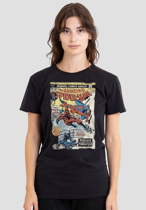 Young woman wearing black t-shirt with vintage Amazing Spider-Man comic cover featuring Spider-Man and Tarantula fighting.