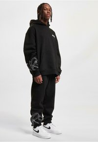 Rocawear Tracksuit bottoms - black