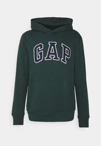 Donkergroene hoodie met een buidelzak, voorzien van het woord "GAP" in witte en marineblauwe vetgedrukte letters over de borst. Katoenen materiaal.
