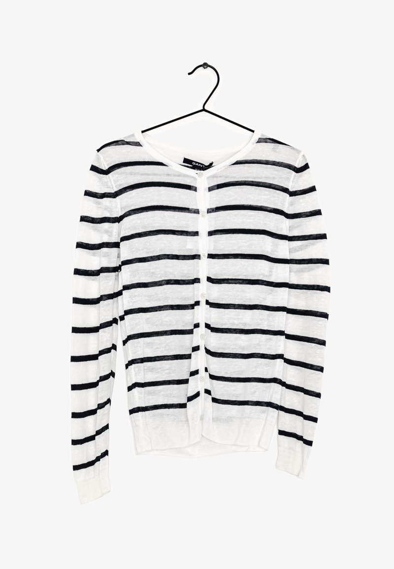 Hvid cardigan med marineblå vandrette striber, knaplukning, lange ærmer og ribbet kant. Fremstillet af letvægts, let struktureret materiale.