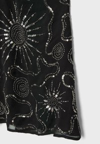 Black fabric with silver sequins forming sunburst and spiral patterns connected by wavy lines, creating a shimmering decorative design.