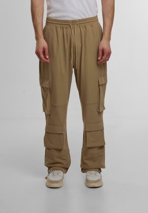 Beige cargos med elastisk midjebånd, snor og flere sidelommer, laget av myk stoff med en avslappet passform.