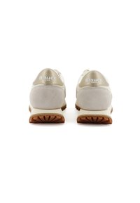 Scarpe da atletica beige con dettagli in suede e suola in gomma. Presentano un colletto imbottito e un logo impresso sul tallone. Design minimalista.
