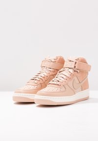 Beige högsneakers med läder- och mockapaneler, vadderad vrist, snördesign och justerbart spänne. Gummisula med mönstrat mönster.