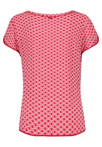 Haut à manches courtes rouge avec un motif géométrique blanc. Il présente un col rond et une bordure rouge contrastante le long du col et de l'ourlet.