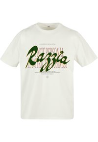 Cream-colored cotton t-shirt featuring bold green and purple text. "Razzia" is prominently displayed with additional text below. Short sleeves, relaxed fit.