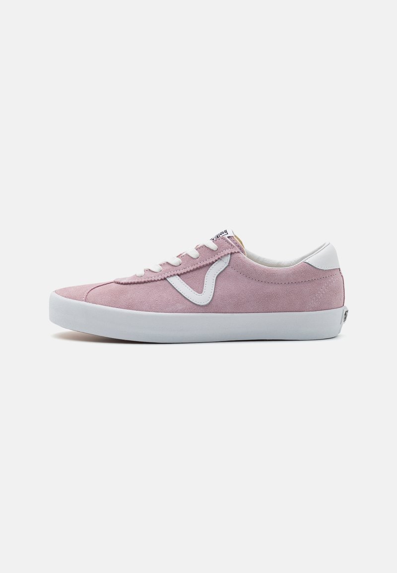 Pink suede sneaker with white accents, flat white rubber sole, lace-up design, and a logo tag on tongue. Smooth texture, low-profile shape.