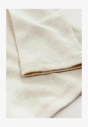 Cieptuie fără cusături de culoare bej deschis, cu margini îndoite și textură subtilă. Material neted și ușor elastic.