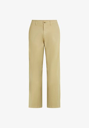 Smėlio spalvos medvilninės kelnės tiesiomis kojomis, su priekyje užsegimu mygtuku ir diržo kilpelėmis. Lygi tekstūra be raštų.