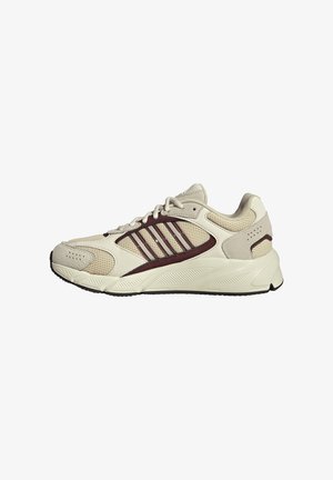 Beige athletic shoe with mesh and suede upper, burgundy accents, textured midsole, and reinforced toe. Features six eyelets for laces.