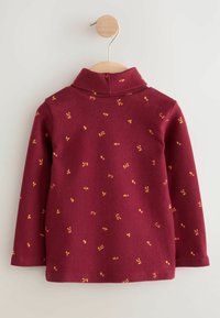 Sudadera de forro polar color burdeos con un cuello alto, que presenta patrones florales amarillos y naranjas dispersos. Las mangas son largas con un bajo recto.