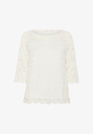 Balta mežģīņu krekls ar apaļu kakla izgriezumu un trīs ceturtdaļu piedurknēm. Malu apdare ar viļņiem, ar ziedu rakstiem visā audumā.